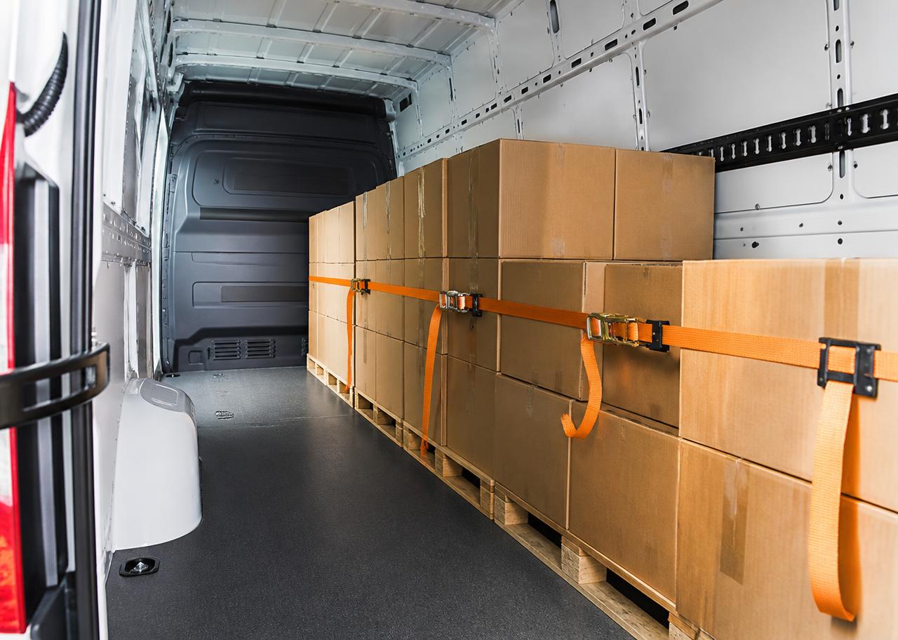 Secured palletized freight strapped inside a high-roof cargo van